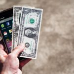 mobile-phone-money-banknotes-us-dollars
