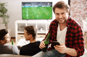 Football Fan Checking Mobile Phone